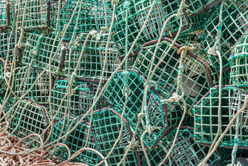 close-up of green mesh fishing traps stacked on a port in Portugal