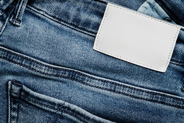 Close-up View of a Pair of Jeans Featuring a Blank Label, Suitable for Personalized Branding or Design. The Fabric Showing Classic Denim Texture and Stitching Details.
