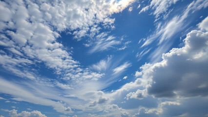 Fragmented clouds, remnants of a passing storm, scatter across the sky, leaving patches of brilliant blue interspersed with wisps of white and gray