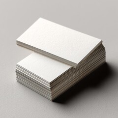 Minimalist blank business cards are stacked elegantly, ideal for branding and design projects. Showcase ideas, promotions, or corporate identity with high-quality versatility.