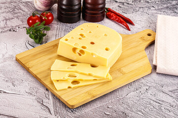 Maasdam cheese piece with slices