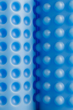 Abstract blue textured surface with holes and bumpy pattern
