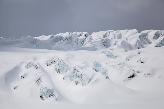 Crevassed glacier ice covered in fresh snow