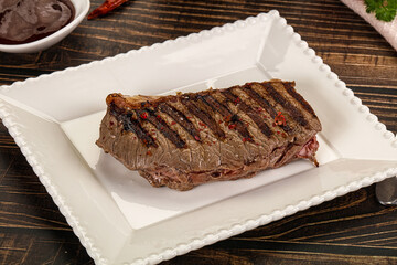 Grilled beef striploin steak with sauce