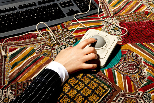 Businesswoman using a trackball mouse at a colorful desk