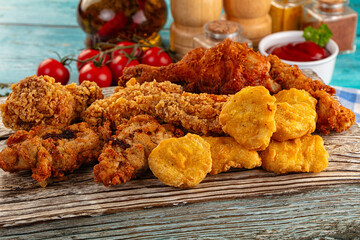 Golden crispy fried chicken mix - wings, drumsticks, nuggets and strips