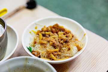 Taiwanese braised vermicelli with minced pork, showcasing traditional flavors and rustic...