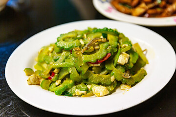 Hakka stir-fried bitter melon with salted egg, vibrant green vegetable dish, savory Hakka cuisine, traditional Taiwanese flavor