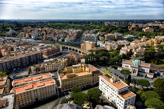 Colorful residential buildings and a curved railway viaduct stretch across a bright European city. This sweeping urban landscape inspires a deep appreciation for infrastructure meeting rich heritage.