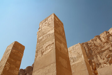 Hieroglyphs and paintings carved in sandstone columns in Hatshepsut temple in Luxor, Egypt