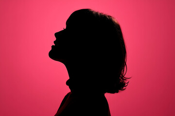 silhouette profile of a woman, Neon pink background