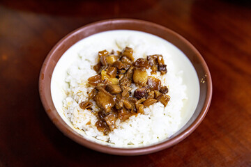 Bowl of traditional Taiwanese lu rou fan, minced pork over white rice, topped with pickled vegetables and soy sauce glaze