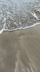 Soft sea wave on sand beach, natural background