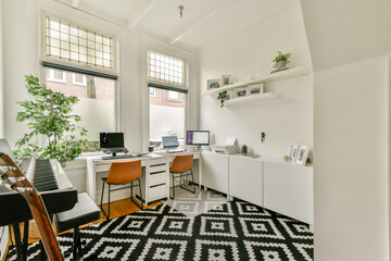 A contemporary home office featuring sleek furniture, bright natural light, and decorative plants. The workspace blends aesthetics with functionality for productivity.