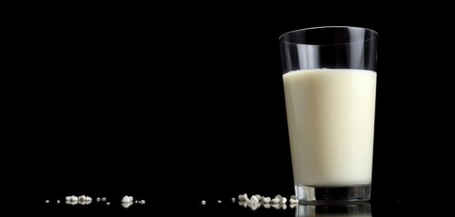 Glass of fresh milk, low angle view against black background,  background, creamy