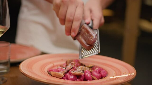 Hands Of The Waiter Grating Bottarga Over The Dumplings Gourmet Dish 