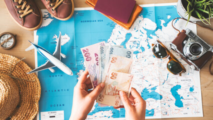 Woman holding money on travel background