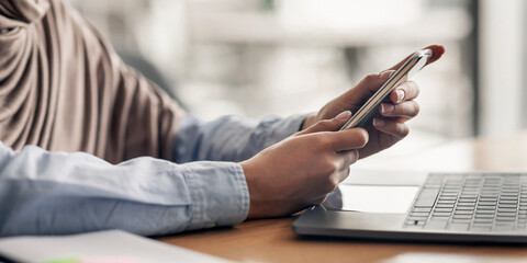 Female hands holding mobile phone and using laptop, freelancer working at cafe, cropped, copy...