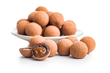 Chocolate truffles with cocoa powder and caramel filling  isolated on white background.