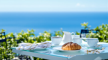 ocean view breakfast setting with croissants and tea