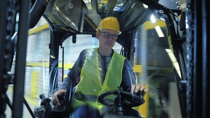 A man in a yellow hard hat and safety vest drives a forklift, navigating the bustling warehouse. The camera captures the action from a first-person perspective, immersing the viewer in the experience.