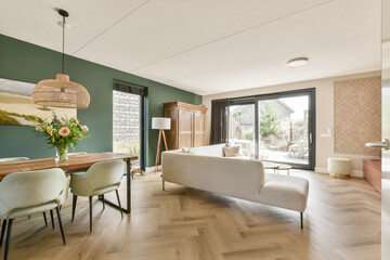 Stylish modern living room featuring elegant furnishings, chic decor, and a seamless connection to outdoor space, offering comfort and sophistication.