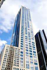 Obraz premium modern beige and blue glass skyscraper