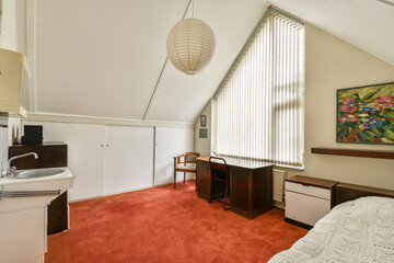 A stylish and modern interior featuring a warm color palette, minimal furniture, large windows, and artistic decor that creates a welcoming ambiance.