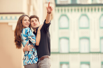 Man points a finger at hand in the direction of something interesting. Love story man and woman who...