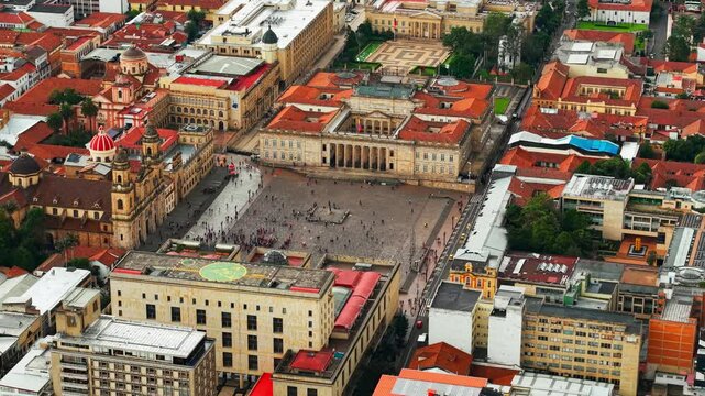 Aerial orbit establishing in telephoto of the Bolivar square and the national capitol of Colombia, Bogota, tourist district of La Candelaria.