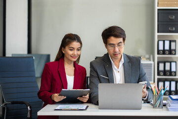 Businessmen team or financial data analysts working with tablets and laptop computers and data...