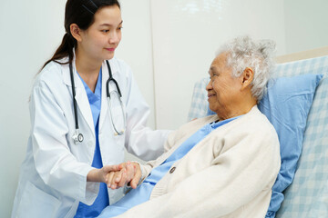 Asian doctor checking and treat elderly woman patient health in hospital.