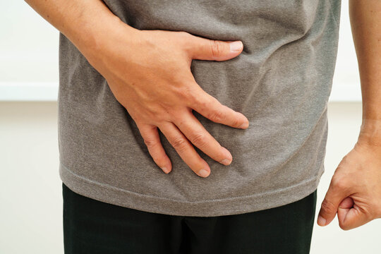 Hernia, Asian man stomach ache, abdominal pain and urology problem health.