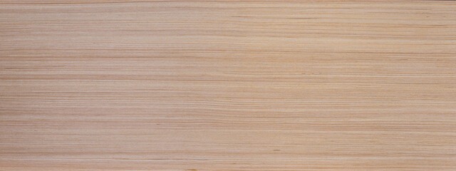 Detailed close up of light brown wood grain texture background showing growth rings