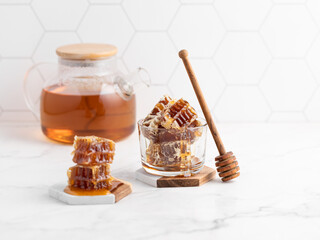 sweet honey in a glass jar and honeycombs
