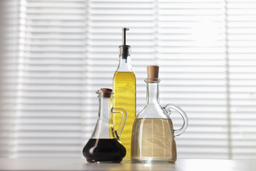 Salad dressings in bottles on table indoors