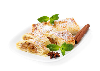 Tasty apple strudels with powdered sugar, mint and spices isolated on white