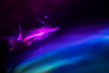 Abstract blurred colorful lens flare bokeh on black,