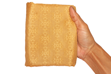 Male Hand Holding Folded Golden Yellow Patterned Fabric on Transparent Background for Product Display and Textile Design