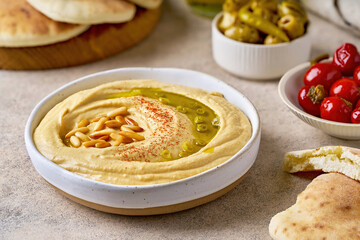 Chickpea hummus plate with pine nuts and olive oil. Closeup view,