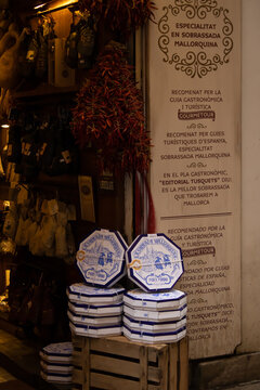 Palma de Mallorca, Spain - March 4, 2025 - Vertical image of boxes of ensaimadas stacked outside a typical Mallorcan shop