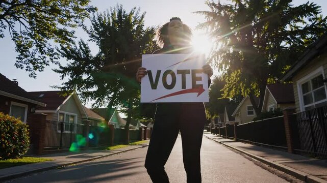 Woman holding 'Vote' sign, encouraging civic participation in peaceful protest