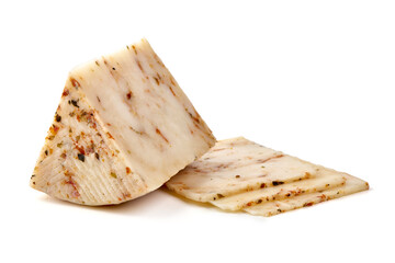 Seasoned cheese wedge with herbs and spices, isolated on white background.