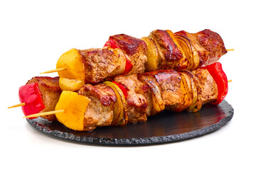 Grilled pork kebabs with vegetables on skewers, isolated on white background.