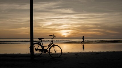 Fototapeta premium Tranquil Sunset Beach Scene with Bicycle