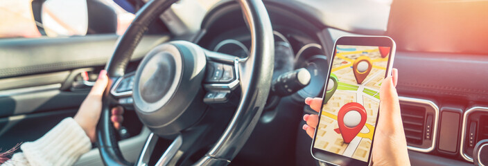 Female Driver Using Navigation Device in Car