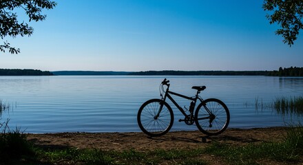 Fototapeta premium Tranquil lake scene with bicycle at the shoreline.