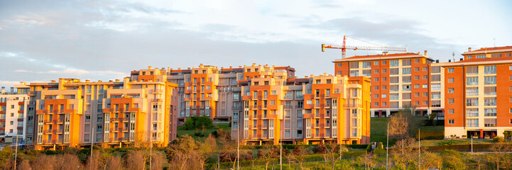Fototapeta premium An urban property image with a row of flats and apertments in early morning sun light. Urban street scene picture. Property sales and estate agent concept. Copy space.