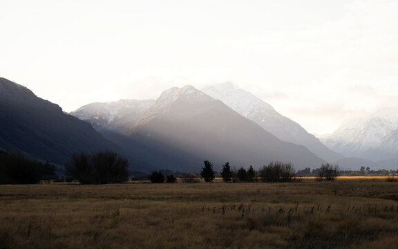 Alpine mountain panorama of the Southern Alps infront of browntop grass meadow near Glacier Burn Track start Kinloch Lake Wakatipu Otago New Zealand