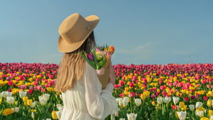 girl in a beautiful field with tulips
